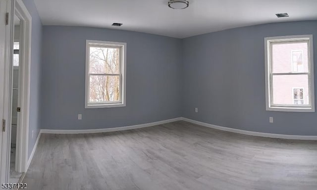 unfurnished room featuring light wood-type flooring and baseboards