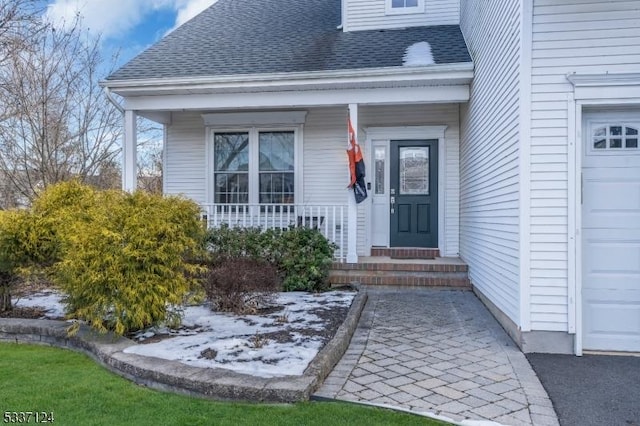 entrance to property with a garage and a porch