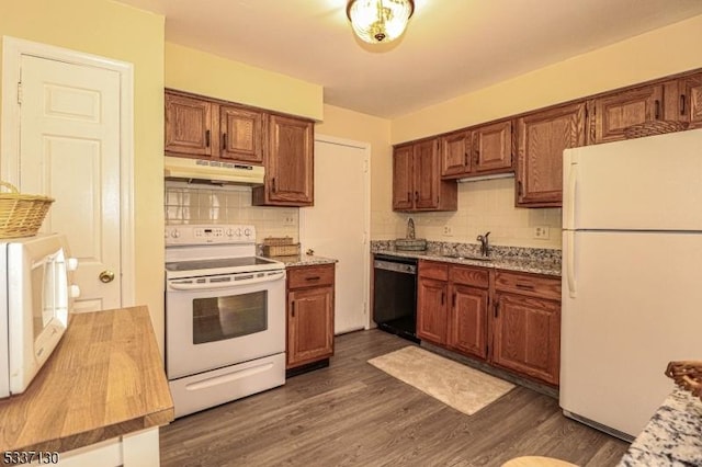 kitchen with dark hardwood / wood-style flooring, sink, white appliances, and decorative backsplash