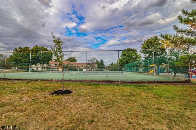 view of sport court featuring a lawn and a playground