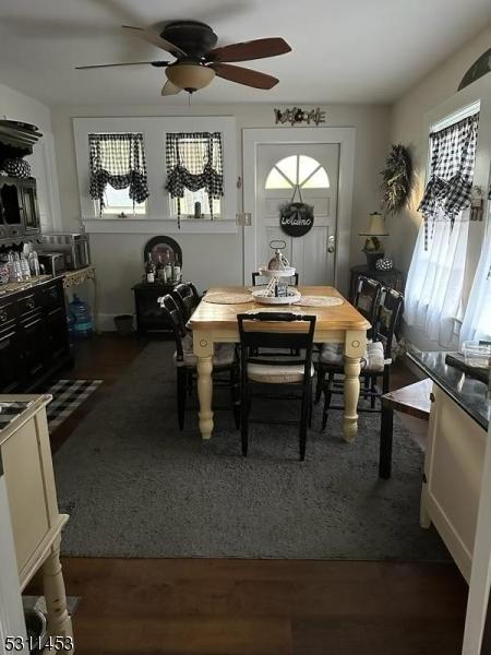 dining space featuring dark hardwood / wood-style floors and ceiling fan