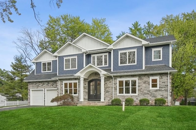 view of front facade with french doors, a garage, and a front yard