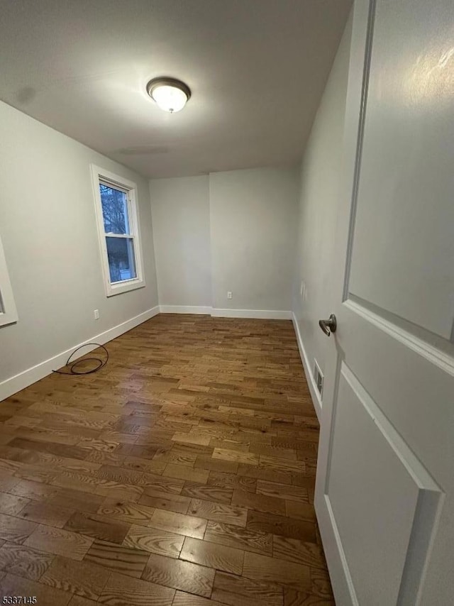 unfurnished room with hardwood / wood-style flooring