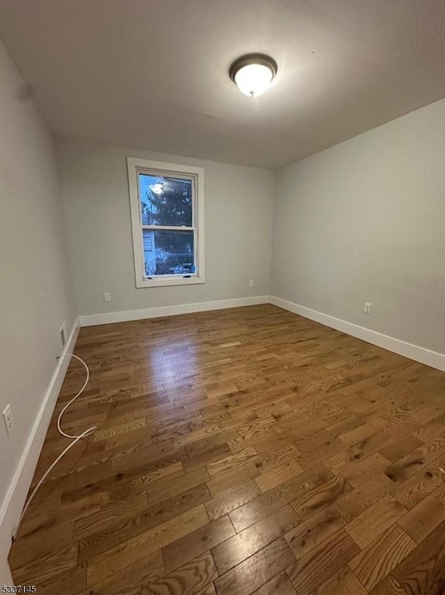 spare room with hardwood / wood-style flooring