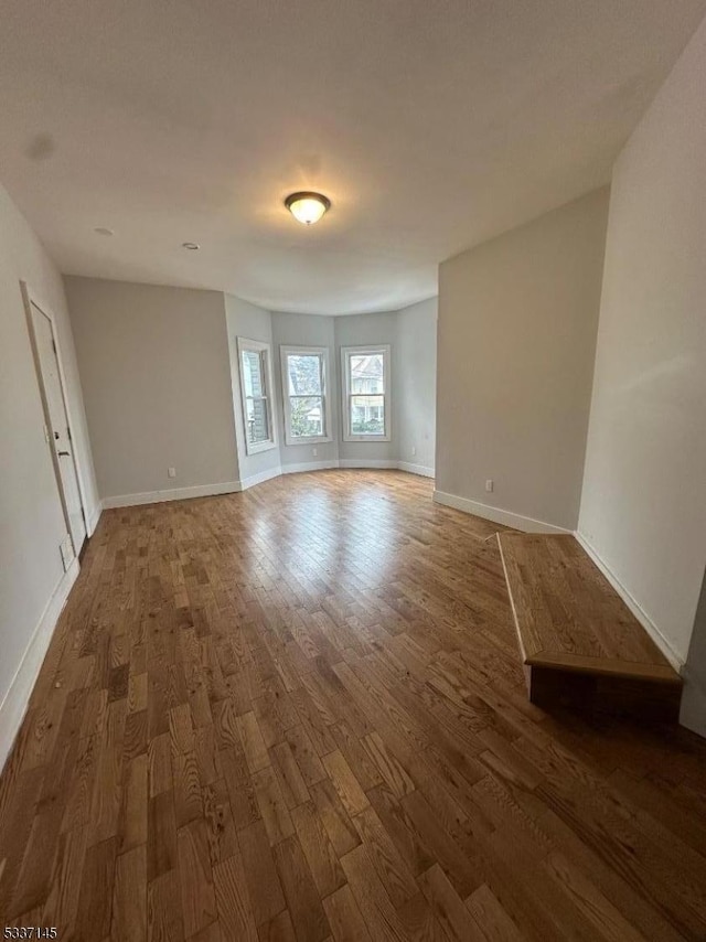 unfurnished living room with dark wood-type flooring