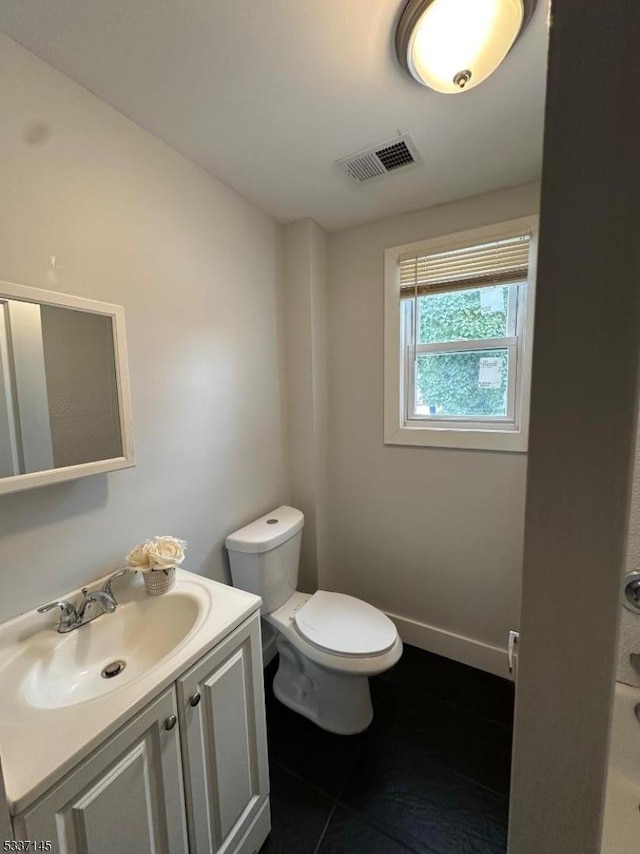 bathroom featuring vanity and toilet