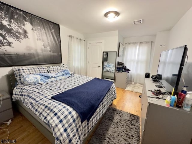 bedroom with hardwood / wood-style flooring