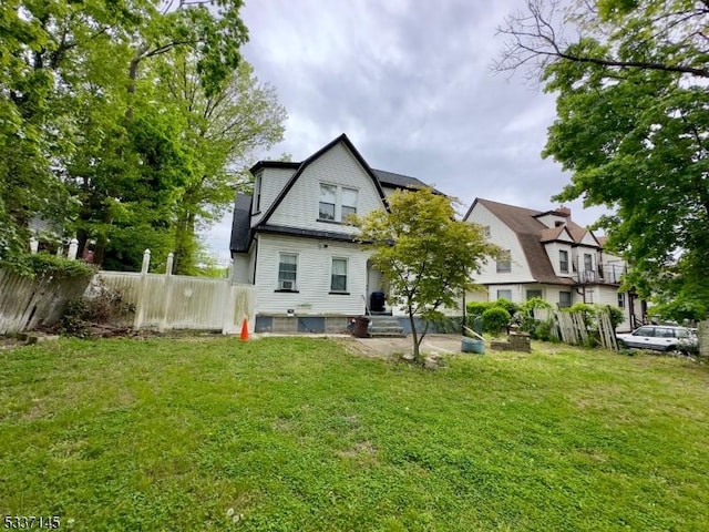 rear view of house featuring a yard