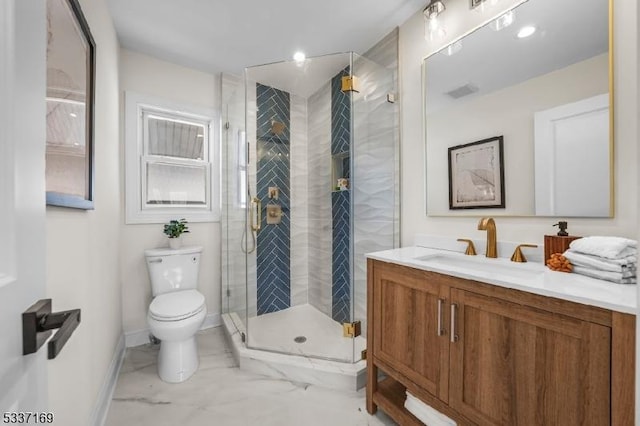 bathroom with vanity, toilet, and an enclosed shower