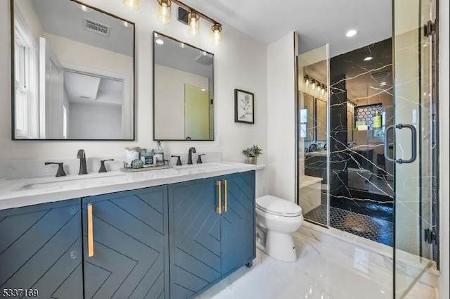 bathroom with a shower with door, vanity, and toilet