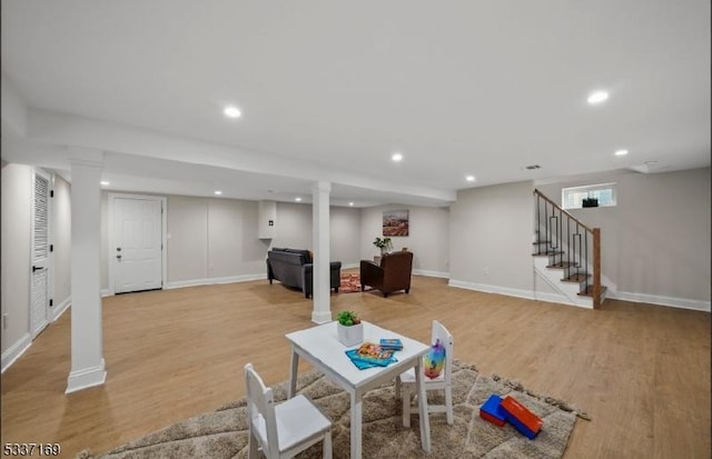 recreation room with light hardwood / wood-style floors and ornate columns