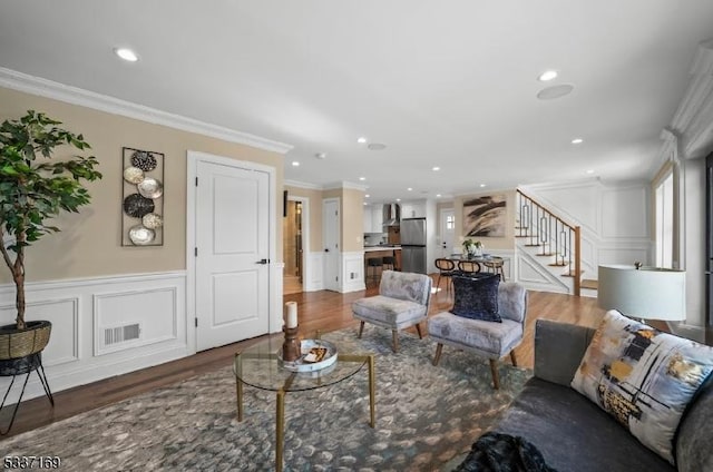 living room featuring dark hardwood / wood-style flooring and crown molding