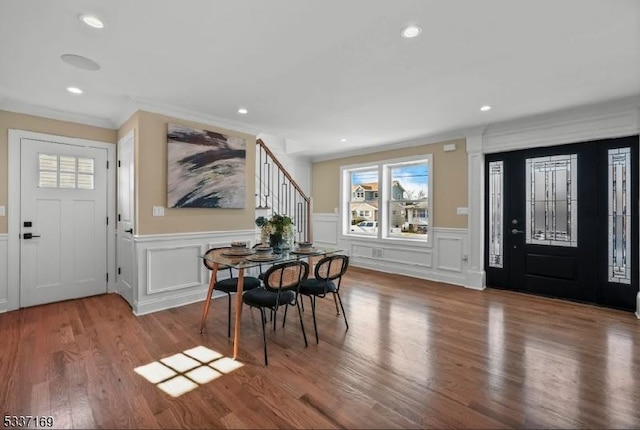 entrance foyer with hardwood / wood-style flooring and ornamental molding