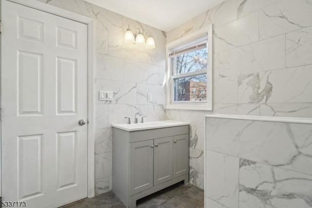 bathroom featuring vanity and tile walls