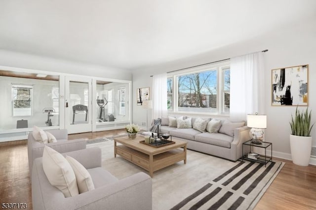 living room featuring light hardwood / wood-style floors and a wealth of natural light