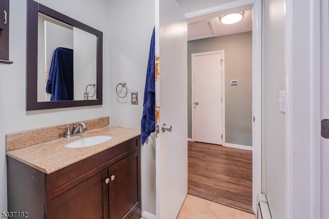 bathroom with a baseboard heating unit and vanity