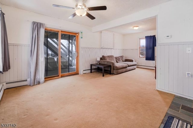 living room with a baseboard radiator, light carpet, and ceiling fan