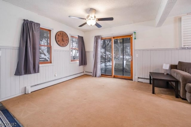 sitting room with a textured ceiling, light colored carpet, and a baseboard radiator