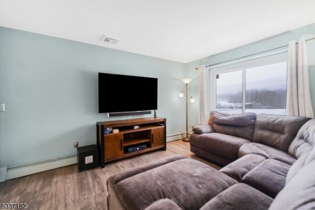 living room with a baseboard radiator and wood-type flooring