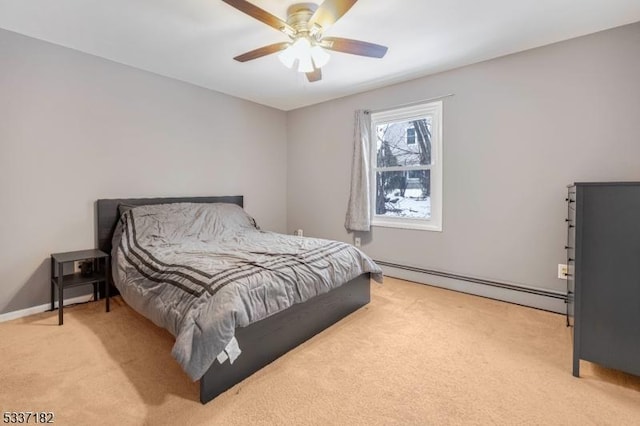 carpeted bedroom featuring baseboard heating and ceiling fan