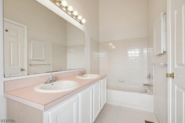 bathroom featuring tile patterned floors, double vanity, and a sink