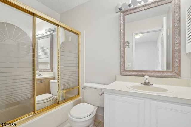 bathroom with bath / shower combo with glass door, toilet, and vanity