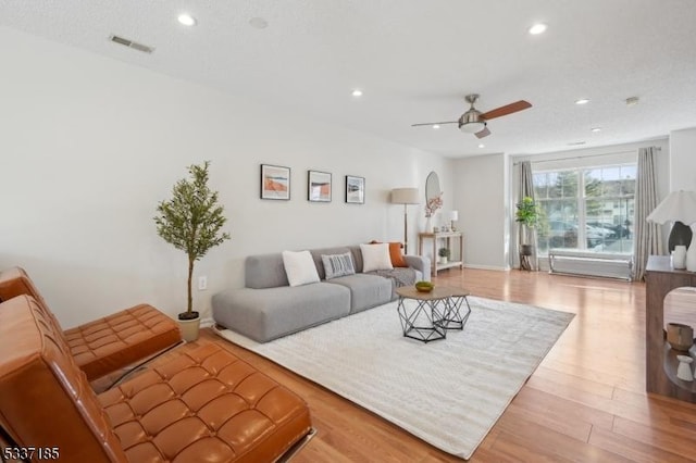 living room with recessed lighting, wood finished floors, visible vents, and ceiling fan