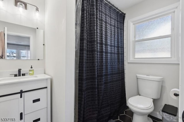 bathroom with vanity, a healthy amount of sunlight, curtained shower, and toilet