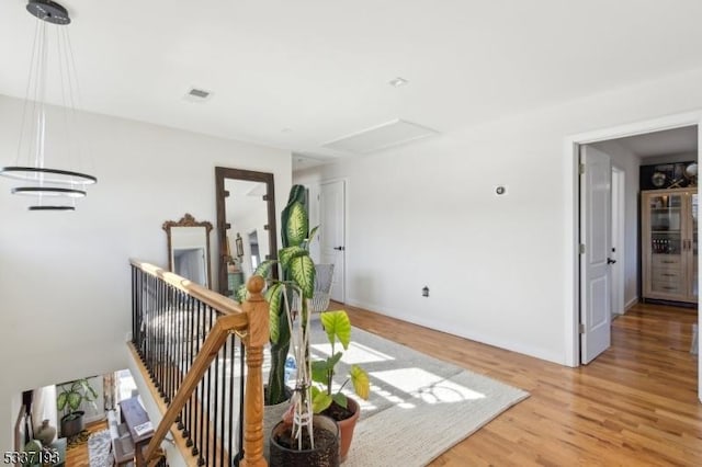 corridor with light hardwood / wood-style floors