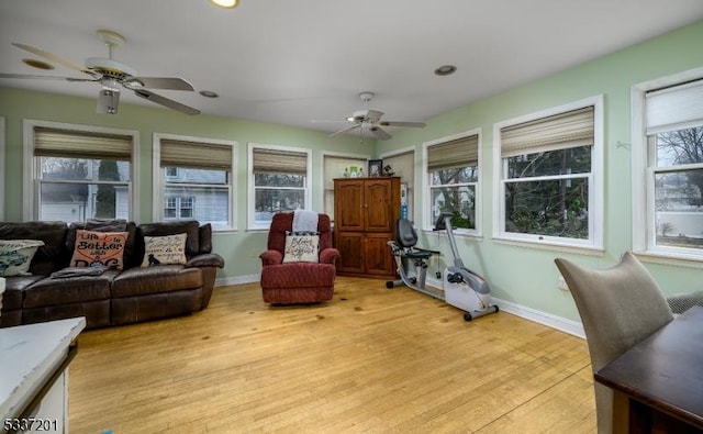 sunroom featuring ceiling fan