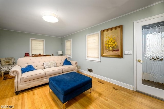 living room with wood-type flooring and ornamental molding