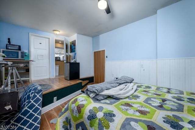 bedroom featuring hardwood / wood-style flooring and ceiling fan