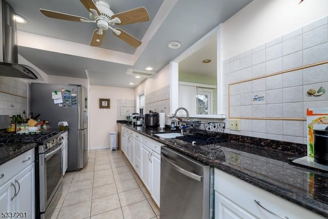 kitchen featuring stainless steel appliances, extractor fan, and white cabinets