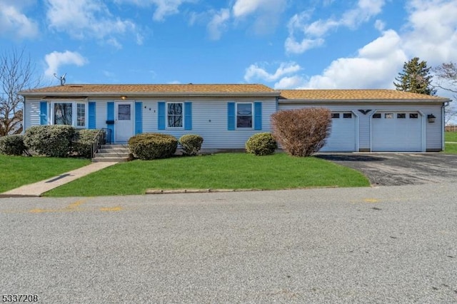 ranch-style house with a front yard, a garage, and driveway