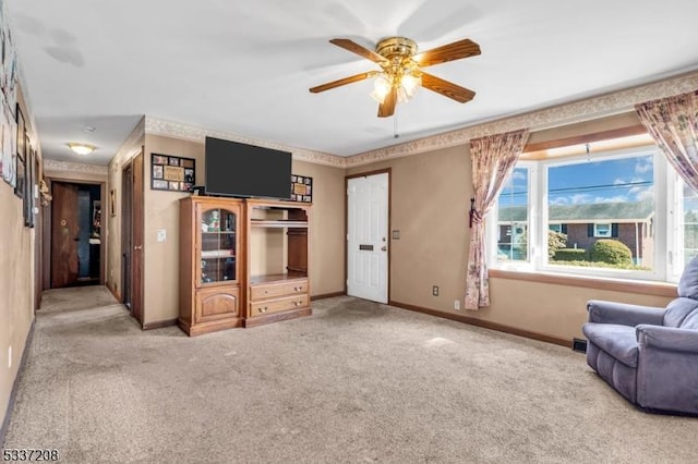 interior space featuring carpet flooring, ceiling fan, and baseboards