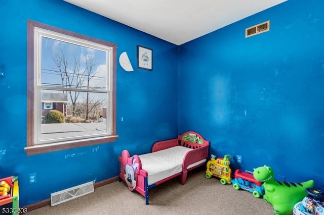 unfurnished bedroom featuring visible vents, carpet flooring, and baseboards