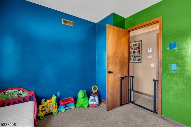 rec room with visible vents, baseboards, and carpet