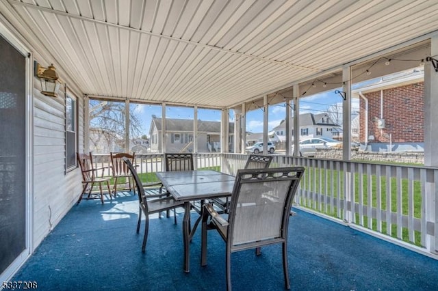 unfurnished sunroom featuring a residential view