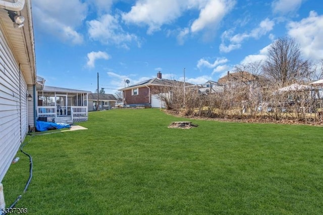 view of yard with a sunroom