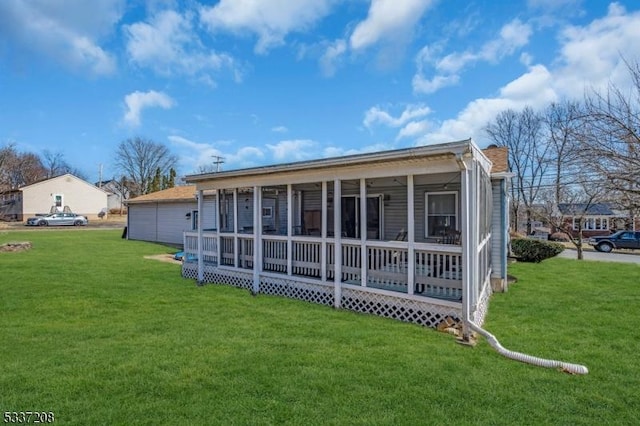 rear view of house featuring a lawn