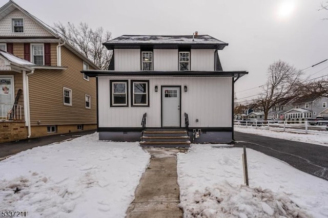 view of front of home featuring fence