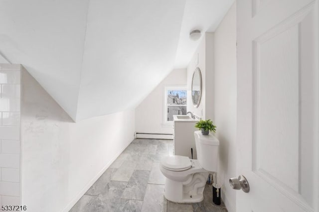 bathroom with lofted ceiling, sink, toilet, and baseboard heating