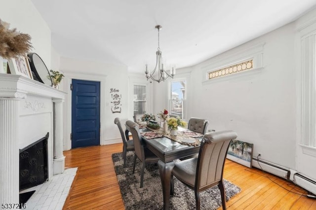 dining room featuring a notable chandelier and light hardwood / wood-style flooring