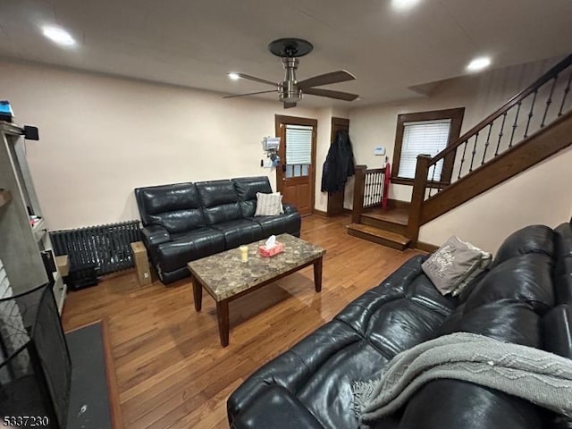 living room with hardwood / wood-style flooring and ceiling fan