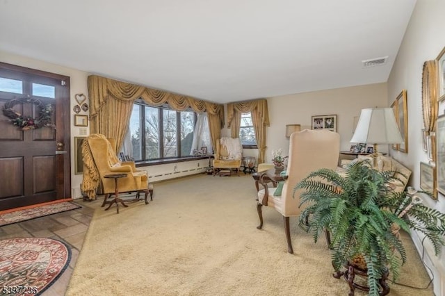 sitting room with a baseboard radiator and carpet