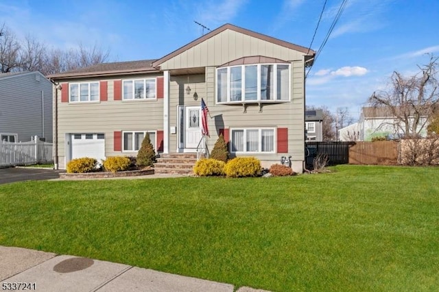 bi-level home with a garage and a front yard