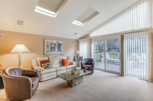 living room with a skylight, high vaulted ceiling, and carpet