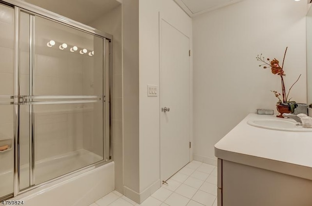 bathroom with tile patterned floors, vanity, and shower / bath combination with glass door