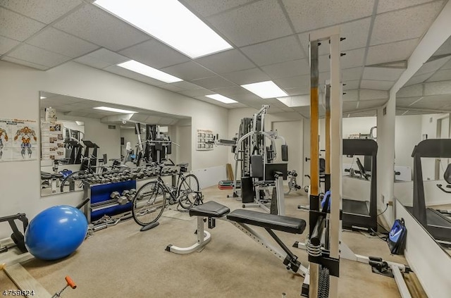 gym with a paneled ceiling