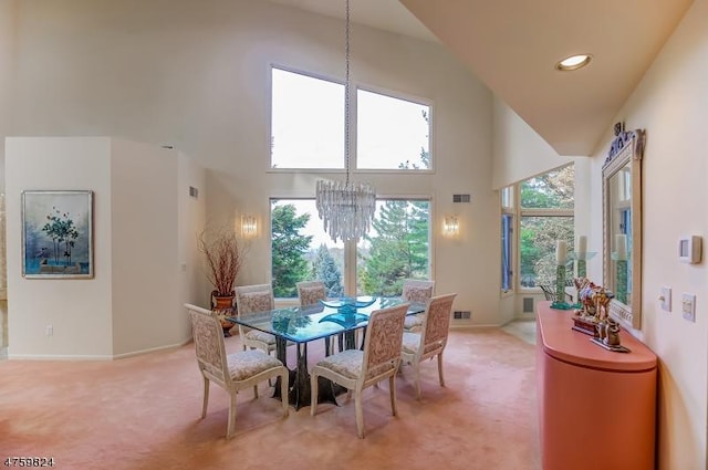 dining space with an inviting chandelier, light colored carpet, and a high ceiling